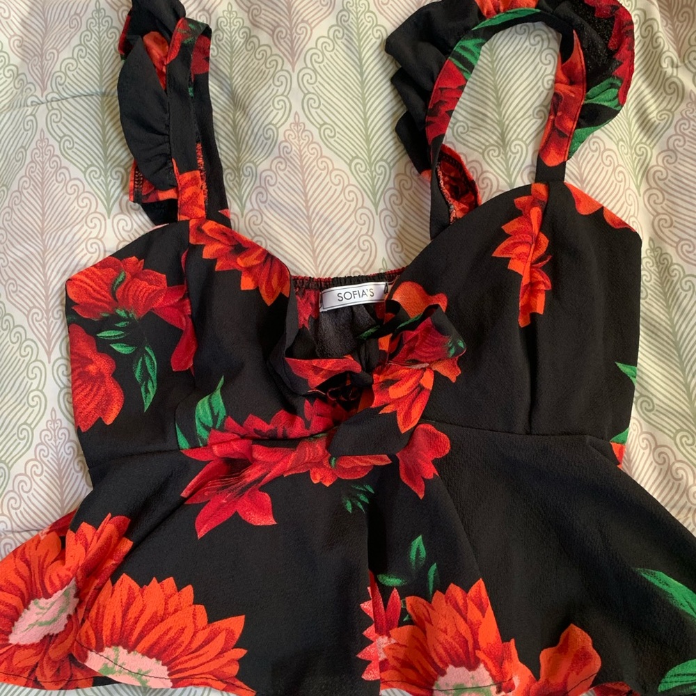 A black and red flowers crop top with a bow in front of chest area to tie.